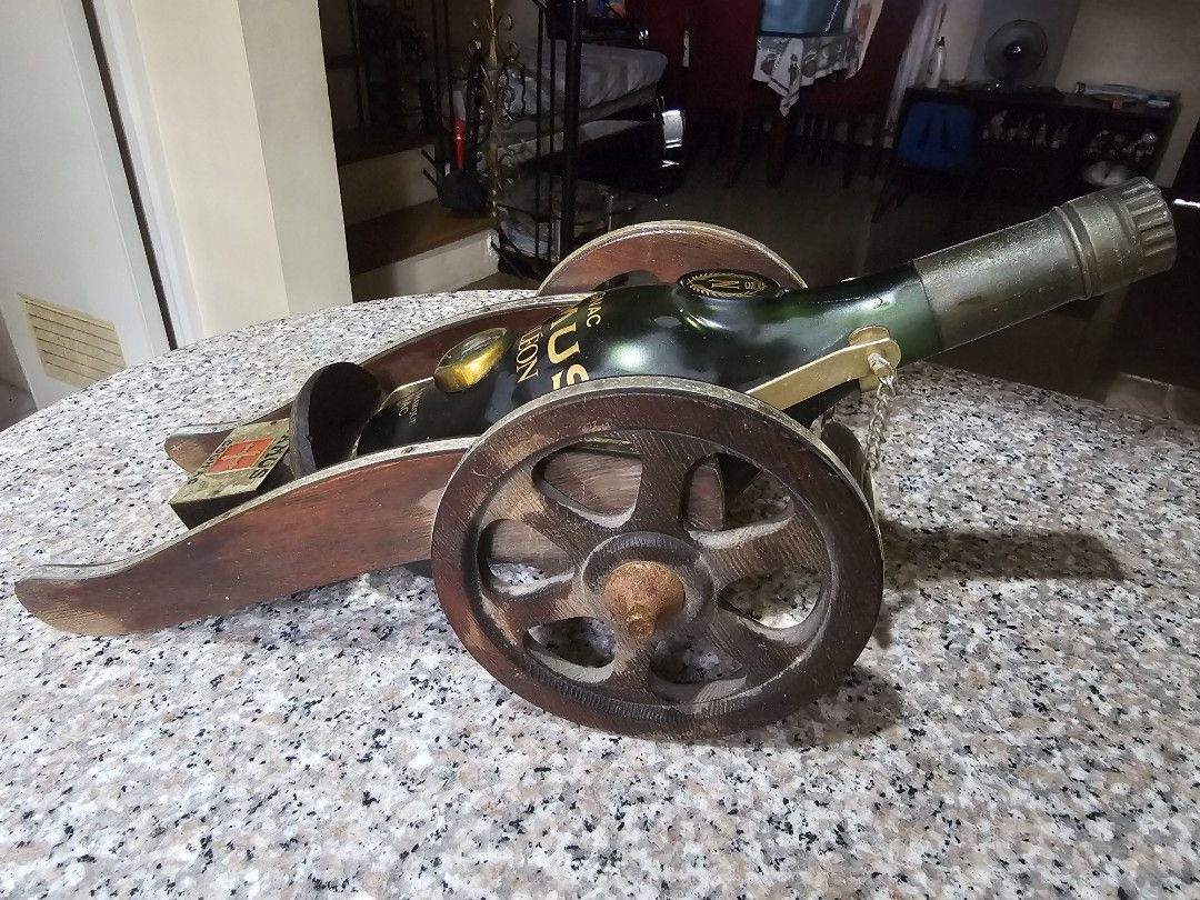 Camus Napoleon Cognac Cannon Bottle Display (Category: Vintage Collectibles) located in Marilao. Submitted by bcantong (Listing ID 1470152519, Image 3). Description: - Authentic Camus Napoleon cognac bottle shaped like a vintage cannon - Detailed with working wooden carriage wheels and metal accents - Includes original branded display plaque and glass stopper - Heavy, solid build ideal for home bars and display cabinets - Excellent collector's it