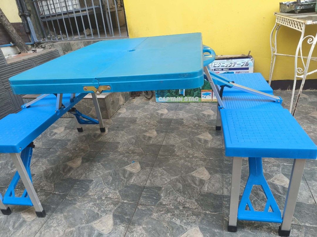Captain Stag Folding Picnic Table with Benches Blue (Category: Tables & Sets) located in Muntinlupa City. Submitted by jojiepogi123 (Listing ID 1470176746, Image 3). Description: - Bright blue folding picnic table with attached seats - Folds into a compact carrying case with a built-in handle for easy transport - Sturdy aluminum frame with durable plastic top and benches - Quick and easy setup for camping, backyard gatherings, or outdoor events -