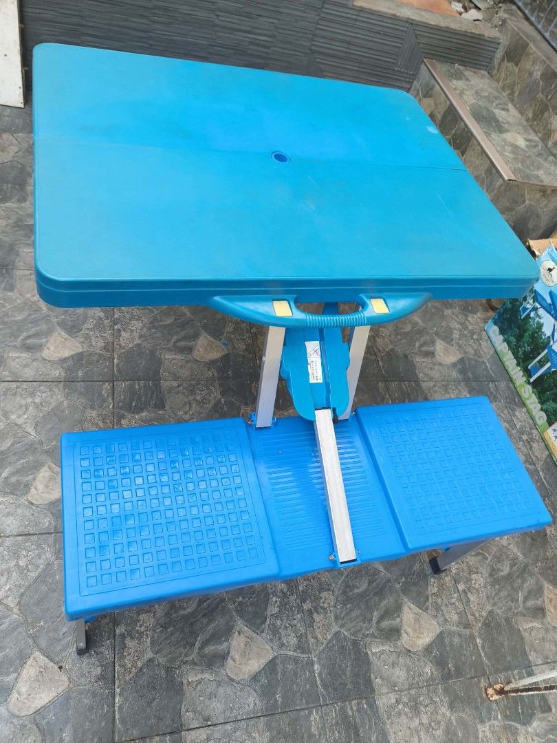 Captain Stag Folding Picnic Table with Benches Blue (Category: Tables & Sets) located in Muntinlupa City. Submitted by jojiepogi123 (Listing ID 1470176746, Image 1). Description: - Bright blue folding picnic table with attached seats - Folds into a compact carrying case with a built-in handle for easy transport - Sturdy aluminum frame with durable plastic top and benches - Quick and easy setup for camping, backyard gatherings, or outdoor events -