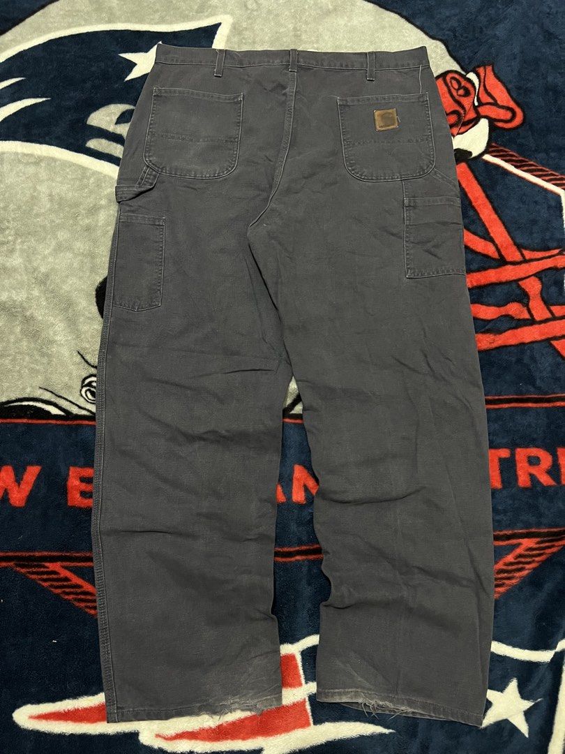 Carhaart Carpenter Work Pants Dark Grey (Category: Jeans) located in Tanza. Submitted by 1954_street (Listing ID 1470306871, Image 1). Description: CARHARTT CARPENTER PANTS 40 waist 45 length 10 leg opening minor tattered hem 1800 - Brand: Carhartt - Color: Dark Grey - Style: Classic carpenter work pants with metal button fly - Features: Utility pockets, side hammer loop, and woven brand patch on the back pocket - Condition: Genuine worn-in condi