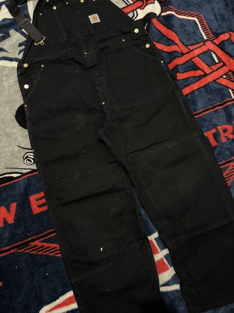 Carhartt Black Double Knee Work Overalls (Category: Jeans) located in Tanza. Submitted by 1954_street (Listing ID 1470306567, Image 3). Description: CARHARTT OVERALL 42 waist 41 length (waist to hem) 10 leg opeing minor tattered parts, minor paint stain but still in crispy condition 3000 - Color: Black - Material: Heavy-duty duck canvas - Design: Double knee reinforcement for durability - Storage: Multiple utility pockets on chest, legs, and back