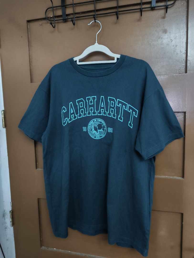 Carhartt WIP Coin Shirt (Category: Tshirts & Polo Shirts ) located in San Pedro. Submitted by madvillainkicks (Listing ID 1470153389, Image 1). Description: Carhartt WIP graphic tee in dark teal green, size medium. Features a collegiate logo and 100% cotton build. DM to order! 24 x 28.