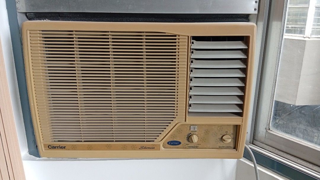 Carrier Silencia Window Type Air Conditioner (Category: Air Conditioning and Heating) located in Pasig City. Submitted by addero747 (Listing ID 1470203615, Image 1). Description: - Brand/Model: Carrier Silencia Window Type Air Conditioner - Color: Classic beige front grille panel - Controls: Easy-to-use manual rotary thermostat and master control knobs - Airflow: Adjustable horizontal louvers on the right side - Condition & Setup: Installed in a 