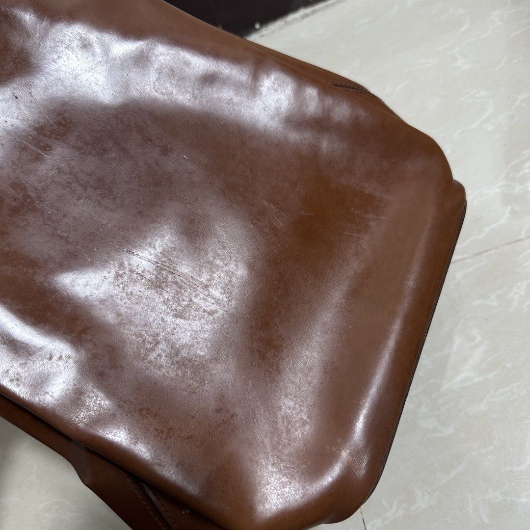 Cartier 1990 Vintage Brown Leather Backpack (Category: Backpacks) located in Manila. Submitted by direcmampu37948 (Listing ID 1470244336, Image 3). Description: - Brand/Era: Authentic vintage Cartier leather backpack from 1990 - Color & Hardware: Rich brown shade paired with silver-tone hardware - Design: Signature ring detail at the top with a versatile, multi-way adjustable strap configuration - Condition Notes: Noticeable surface scratches, sc
