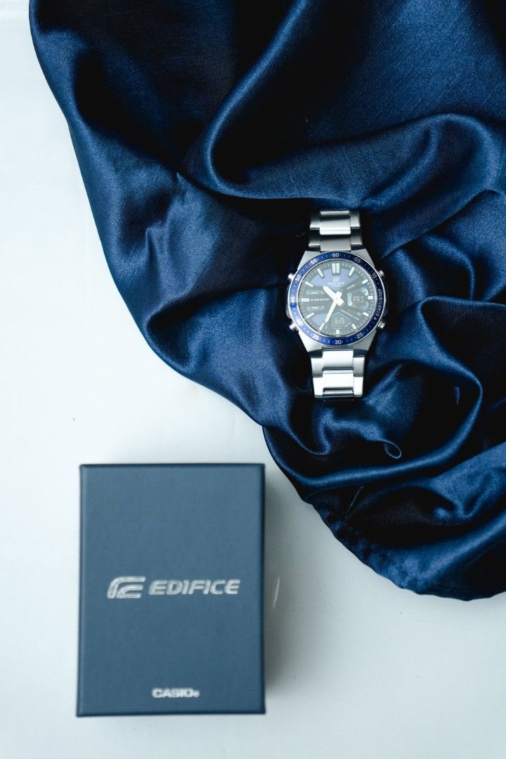 Casio Edifice Steel Watch with Original Box (Category: Men's Watches) located in Marikina City. Submitted by arjay2 (Listing ID 1470267465, Image 1). Description: - Brand: Casio Edifice - Design: Analog-digital display with silver-tone finish and blue bezel/dial - Material: Stainless steel link bracelet - Power: Battery-operated - Inclusion: Original dark blue Edifice presentation box - Condition/Vibe: Classic, sporty, and versatile for casual or