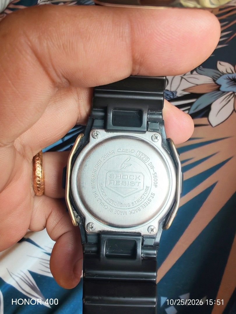 Casio G-Shock DW-5600P Digital Watch (Category: Men's Watches) located in Bacoor. Submitted by alexander_deleon07 (Listing ID 1470223909, Image 2). Description: - Brand: Casio G-Shock - Model: DW-5600P (Module 3229) - Color: Classic black resin case and strap - Extra: Includes stylish gold-tone face protector wire guard - Features: Clear digital display showing time, date, and day - Water Resistance: Up to 20 bar - Condition: Working battery incl