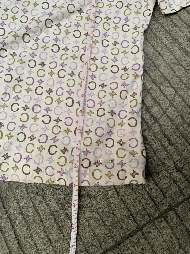CELINE 2000’s ALL-OVER C MACADAM MONOGRAM T-SHIRT (Category: Shirts) located in Davao. Submitted by thrift_cuttiiee1000 (Listing ID 1470265884, Image 3). Description: Celine 2000s All-Over C Macadam Monogram T-Shirt This piece is a lightweight stretch cotton-blend top produced by Celine during the early 2000s Michael Kors era. It features an intricate, pastel all-over micro-monogram print incorporating the house’s historic ‘C’ motif and Triomphe 