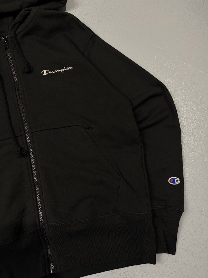 Champion Black Zip-Up Hoodie (Category: Hoodies) located in Cainta. Submitted by rizalthriftstuff (Listing ID 1470327113, Image 2). Description: Champ Zipped Jacket Dimes Size: S Width: 20 Length: 24 Color Rate: 10 Condition: 9 No Issue Mine - ₱400 - Brand: Champion - Style: Zip-up hoodie with drawstring - Color: Black with white embroidered script logo on chest - Size: Small - Details: Classic embroidered 'C' patch on left sleeve, secure front p