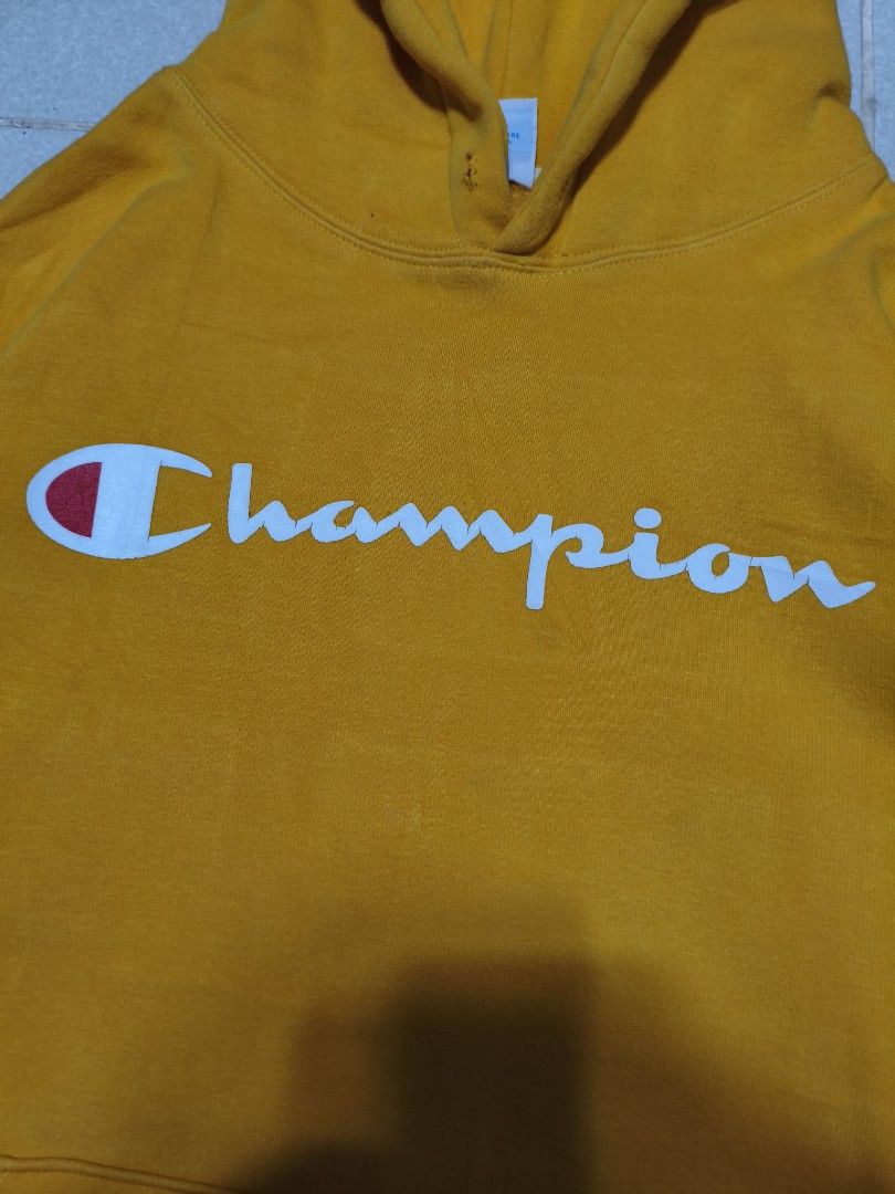 Champion Yellow Hoodie X-Large (Category: Hoodies) located in Bayambang. Submitted by rajuergui76226 (Listing ID 1470322142, Image 3). Description: - Brand: Champion - Color: Bright Yellow with Classic Script Logo - Size: Tagged XL (Fits like Men's Medium or Women's Oversized) - Dimensions: 22" x 27" - Features: Front kangaroo pocket - Condition: 9/10 color rate, solid overall - Flaws: Minor hair-lines, minimal stain, and light signs of use on ri