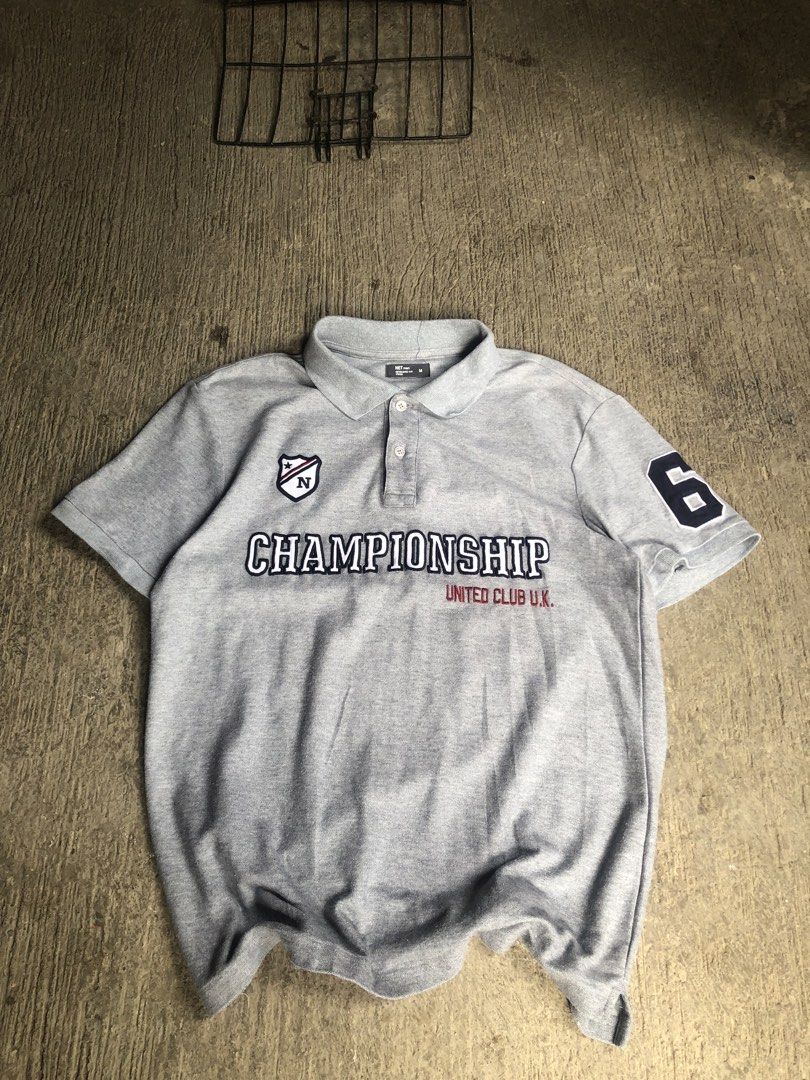 Championship polo men’s (Category: Tshirts & Polo Shirts ) located in Zamboanga. Submitted by wayne_geroche16 (Listing ID 1470309864, Image 1). Description: - Brand: NET men - Color: Grey - Size: Medium (Tagged M) -width: 19.5 -length: 25.5 - Design: Bold Championship United Club U.K. embroidery across the chest - Details: Shield logo patch on right chest, number 6 patch on left sleeve - Features: Classic collar with a three-button placket - Cond