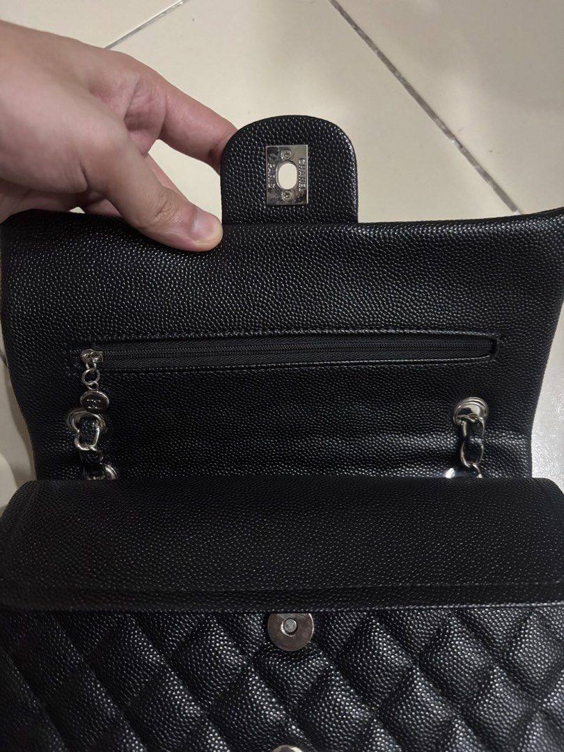 Chanel Black Caviar Leather Double Flap Bag (Category: Luxury Bags & Wallets) located in Manila. Submitted by happy.kira20 (Listing ID 1470177450, Image 3). Description: - Prelovee Chanel Classic Double Flap Handbag - Material: Black quilted caviar leather with burgundy interior lining - Hardware: Silver-tone with iconic interlocking CC turn-lock closure - Strap: Interwoven chain and leather shoulder strap - Interior: Multiple compartments with a