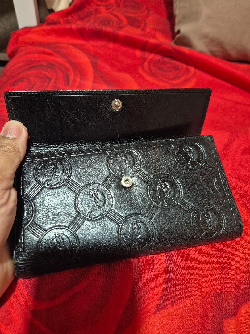 Chanel Black Quilted Embossed Long Wallet (Category: Wallets & Card holders) located in Manila. Submitted by rpaul88 (Listing ID 1470273854, Image 3). Description: - Material: Premium black leather - Design: Debossed circular pattern with foldover style - Closure: Silver CC logo snap closure - Interior: Multiple card slots, spacious compartments, and a silver branding plaque - Condition: Clean inside and out, excellent classic condition !! Not OG