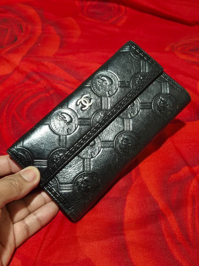 Chanel Black Quilted Embossed Long Wallet (Category: Wallets & Card holders) located in Manila. Submitted by rpaul88 (Listing ID 1470273854, Image 1). Description: - Material: Premium black leather - Design: Debossed circular pattern with foldover style - Closure: Silver CC logo snap closure - Interior: Multiple card slots, spacious compartments, and a silver branding plaque - Condition: Clean inside and out, excellent classic condition !! Not OG