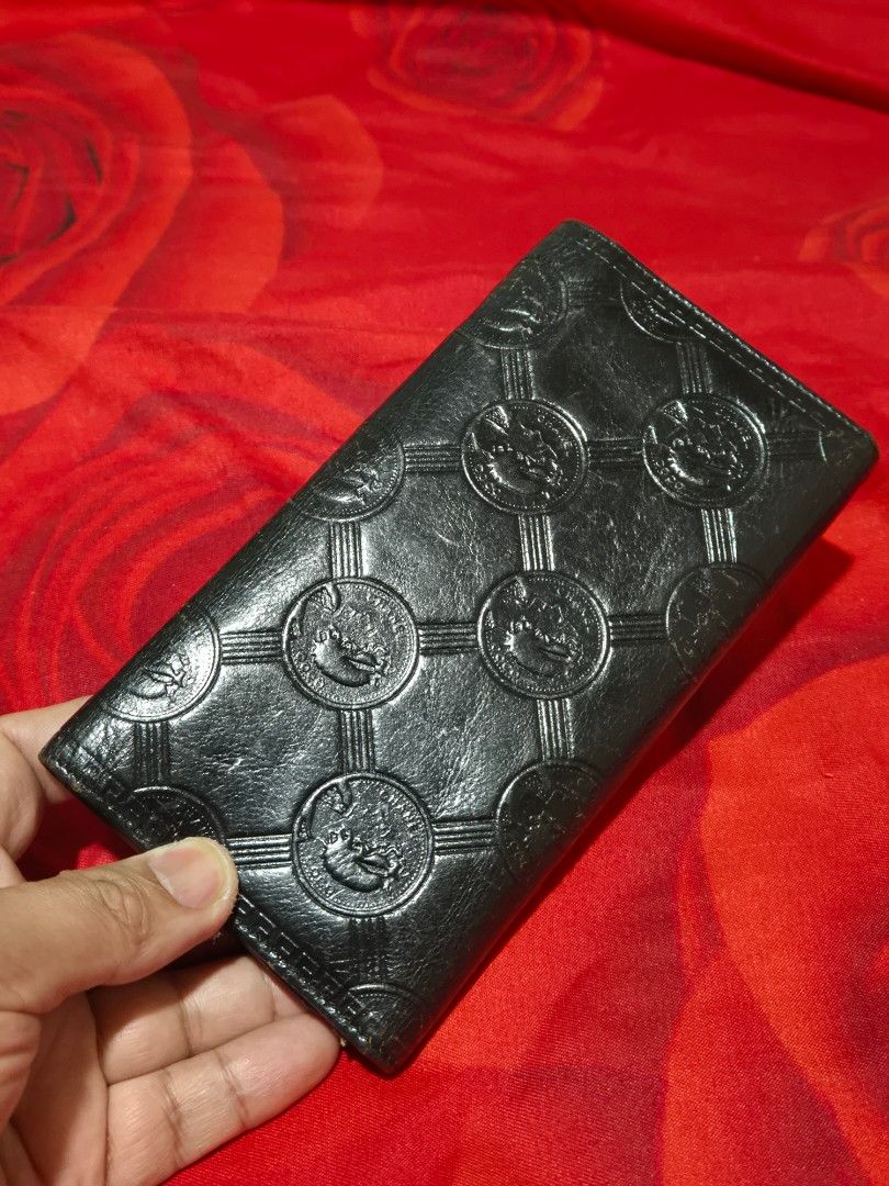 Chanel Black Quilted Embossed Long Wallet (Category: Wallets & Card holders) located in Manila. Submitted by rpaul88 (Listing ID 1470273854, Image 2). Description: - Material: Premium black leather - Design: Debossed circular pattern with foldover style - Closure: Silver CC logo snap closure - Interior: Multiple card slots, spacious compartments, and a silver branding plaque - Condition: Clean inside and out, excellent classic condition !! Not OG