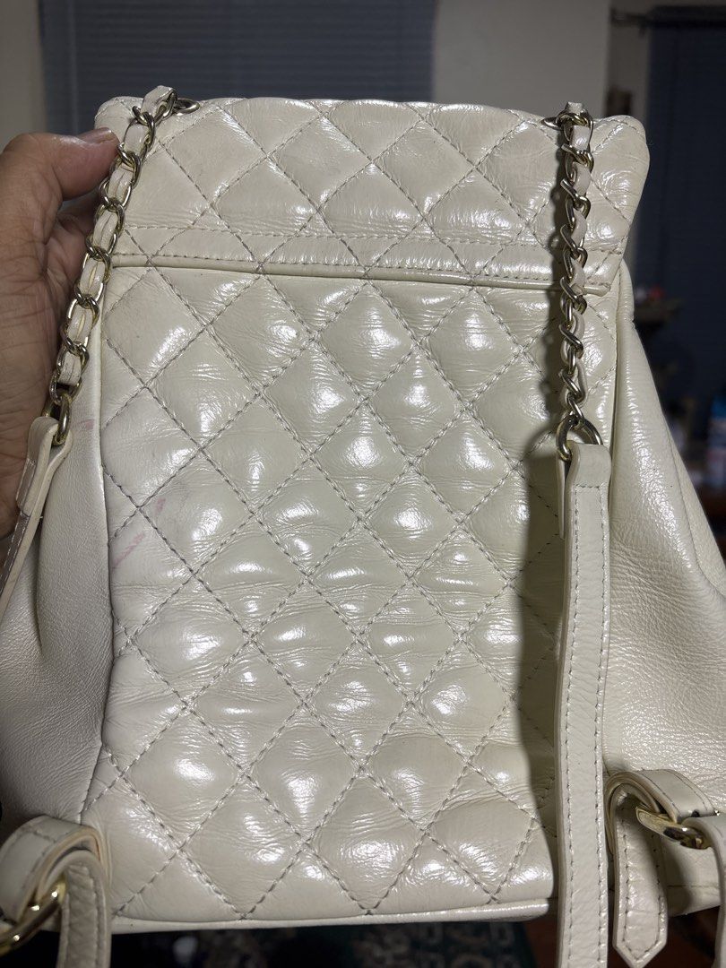 Chanel White Quilted Leather Backpack with Chain Straps (Category: Backpacks) located in Cordova. Submitted by cb_bagz_n_bloom (Listing ID 1470309676, Image 3). Description: white quilted leather Chanel backpack with gold-tone hardware and classic turn-lock closures. Features a structured design, diamond quilting, and interwoven leather and chain straps. Clean and elegant..