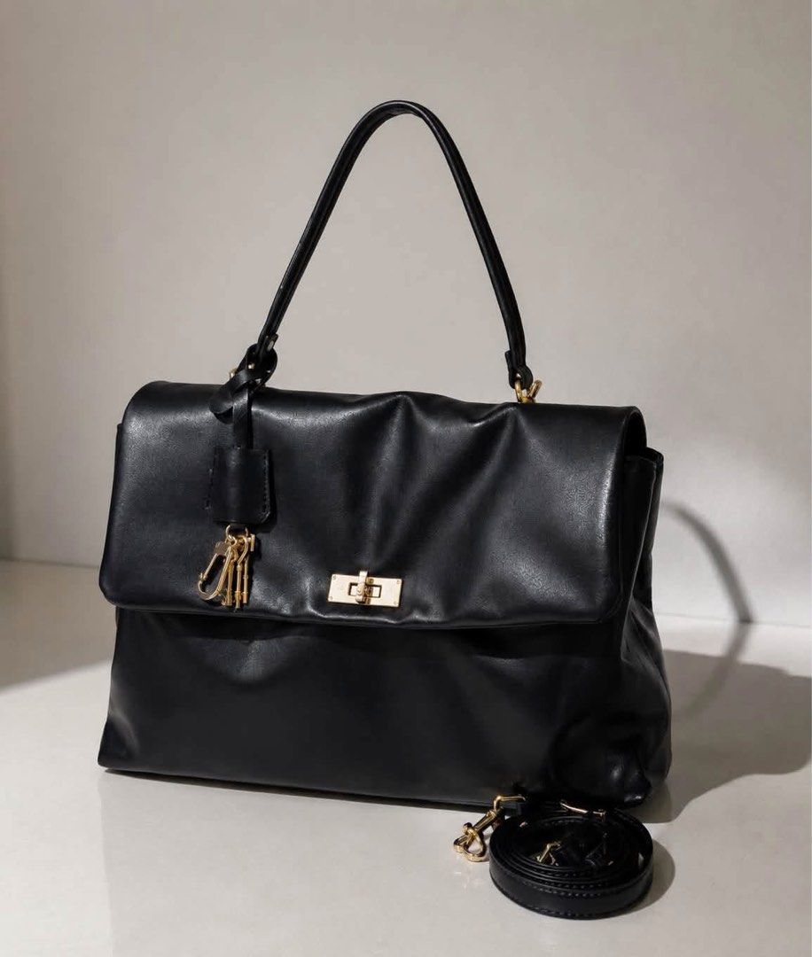 Charles & Keith Black Handbag with Strap (Category: Cross-body Bags) located in Manila. Submitted by manilynpitero (Listing ID 1470143333, Image 1). Description: - Brand: Charles & Keith - Color: Classic Black - Condition: Excellent / Well-maintained - Hardware: Premium gold-tone - Closure: Secure front flap - Versatility: Includes a top handle and a detachable, adjustable long strap - Interior: Clean lining with multiple compartments and one zip
