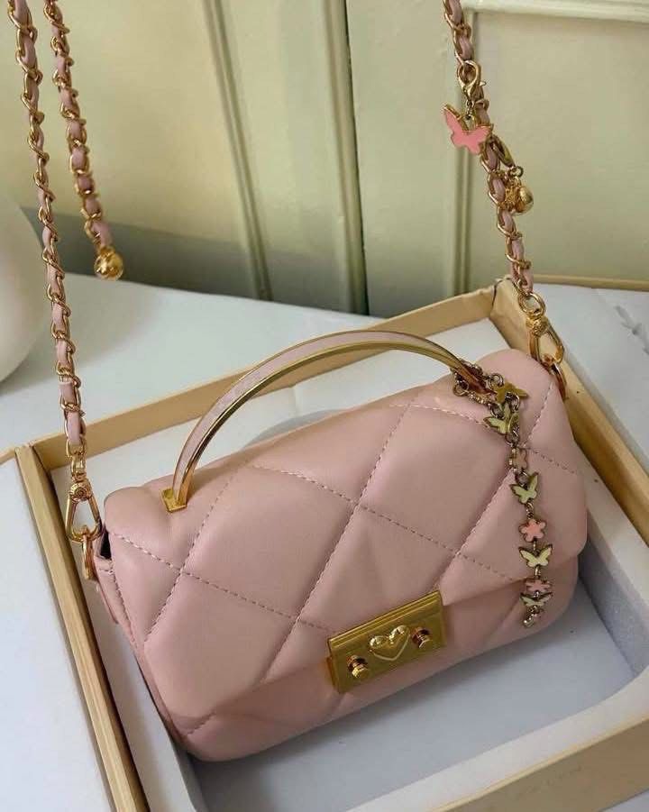 Charles & Keith Quilted Pink Handle Bag Gift Set (Category: Cross-body Bags) located in Manila. Submitted by manilynpitero (Listing ID 1470143470, Image 2). Description: - Brand: Charles & Keith - Style: Pink quilted shoulder bag with gold hardware, top handle, chain strap, and heart clasp closure - Inclusions: Matching butterfly and flower charms, plus an earrings and bracelet set - Packaging: Comes in an original presentation box with ribbon .