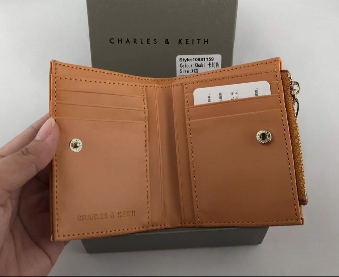 Charles & Keith Quilted Wallet Khaki (Category: Wallets & Card holders) located in Manila. Submitted by manilynpitero (Listing ID 1470143796, Image 2). Description: - Authentic Charles & Keith quilted wallet - Color: Sophisticated Khaki - Style Number: 10681159 - Size: XXS (Compact fold-over design) - Secure snap button closure - Convenient zippered coin compartment on top - Multiple card slots inside for your essentials.