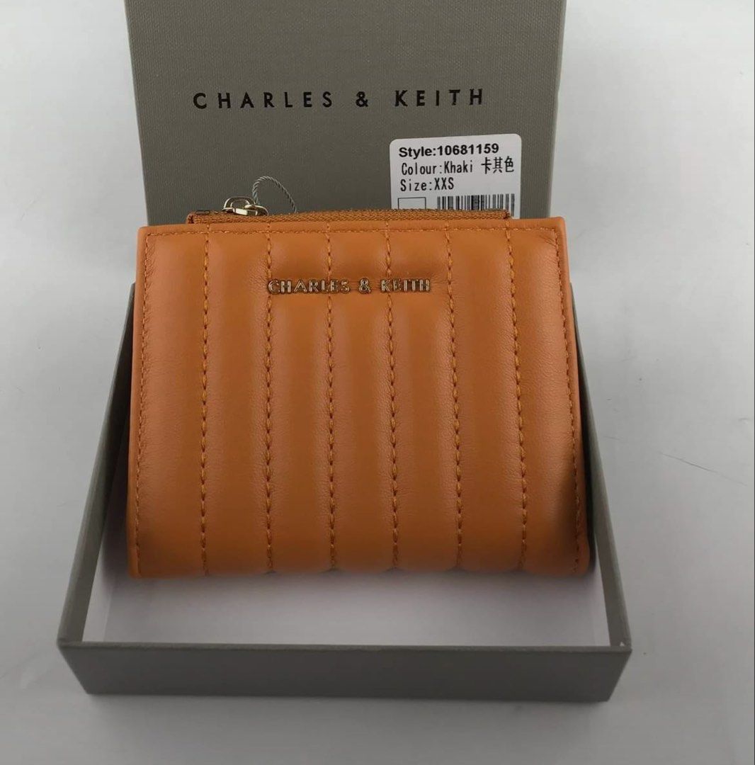 Charles & Keith Quilted Wallet Khaki (Category: Wallets & Card holders) located in Manila. Submitted by manilynpitero (Listing ID 1470143796, Image 1). Description: - Authentic Charles & Keith quilted wallet - Color: Sophisticated Khaki - Style Number: 10681159 - Size: XXS (Compact fold-over design) - Secure snap button closure - Convenient zippered coin compartment on top - Multiple card slots inside for your essentials.