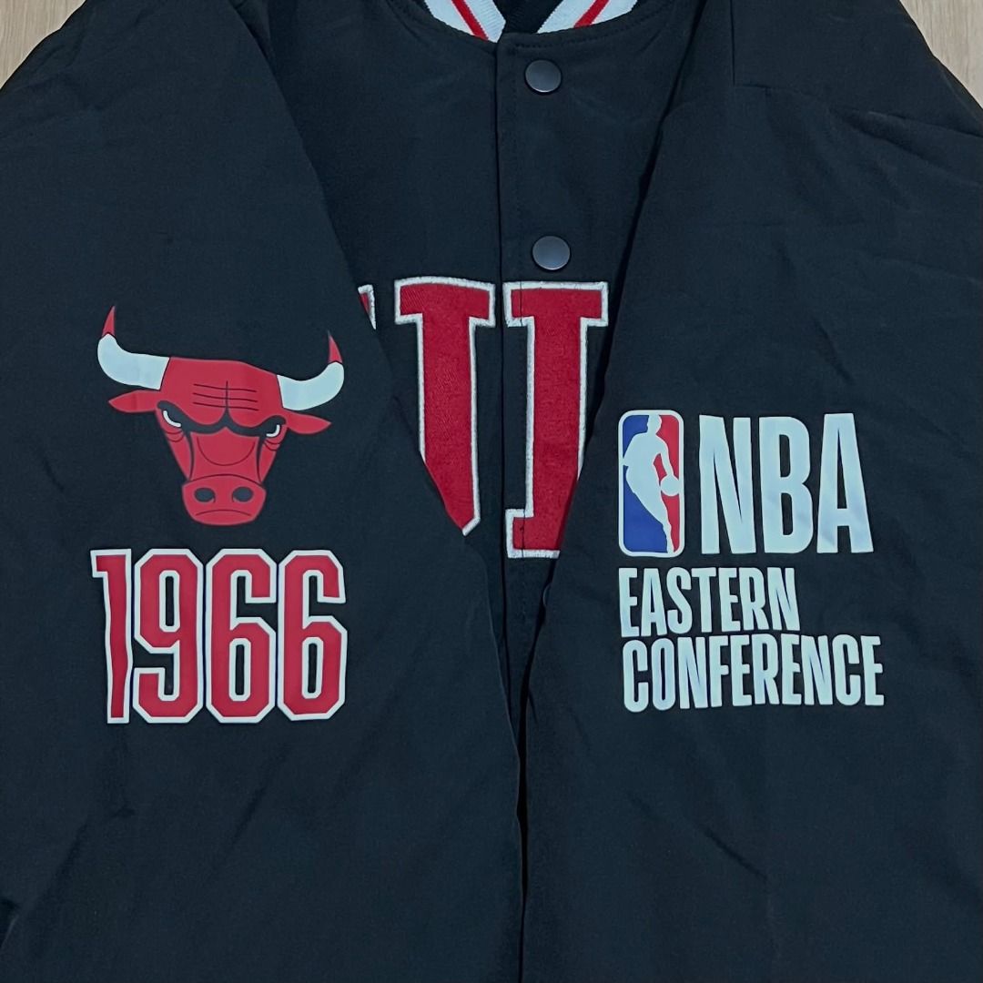 Chicago Bulls NBA Eastern Conference Varsity Bomber Jacket (Category: Coats, Jackets and Outerwear) located in Manila. Submitted by luxurybagsandshoes (Listing ID 1470232949, Image 3). Description: - Brand new with tags still attached - Color: Classic Black - Team: Chicago Bulls branding with large chest lettering and back bull logo - Accents: Unique patch details on both sleeves - Closure: Snap button front - Trim: Striped ribbed collar, cuffs, 