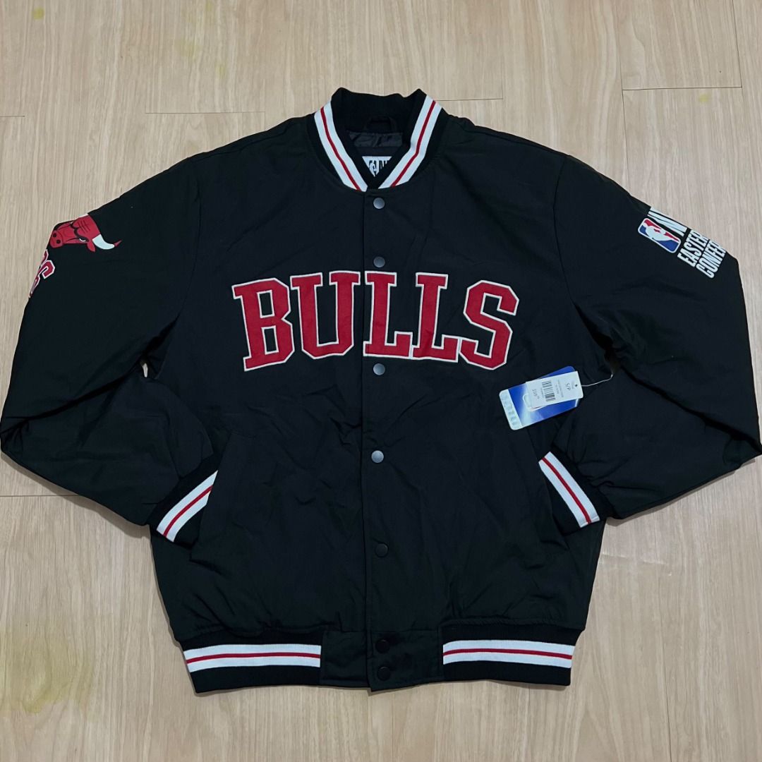 Chicago Bulls NBA Eastern Conference Varsity Bomber Jacket (Category: Coats, Jackets and Outerwear) located in Manila. Submitted by luxurybagsandshoes (Listing ID 1470232949, Image 1). Description: - Brand new with tags still attached - Color: Classic Black - Team: Chicago Bulls branding with large chest lettering and back bull logo - Accents: Unique patch details on both sleeves - Closure: Snap button front - Trim: Striped ribbed collar, cuffs, 