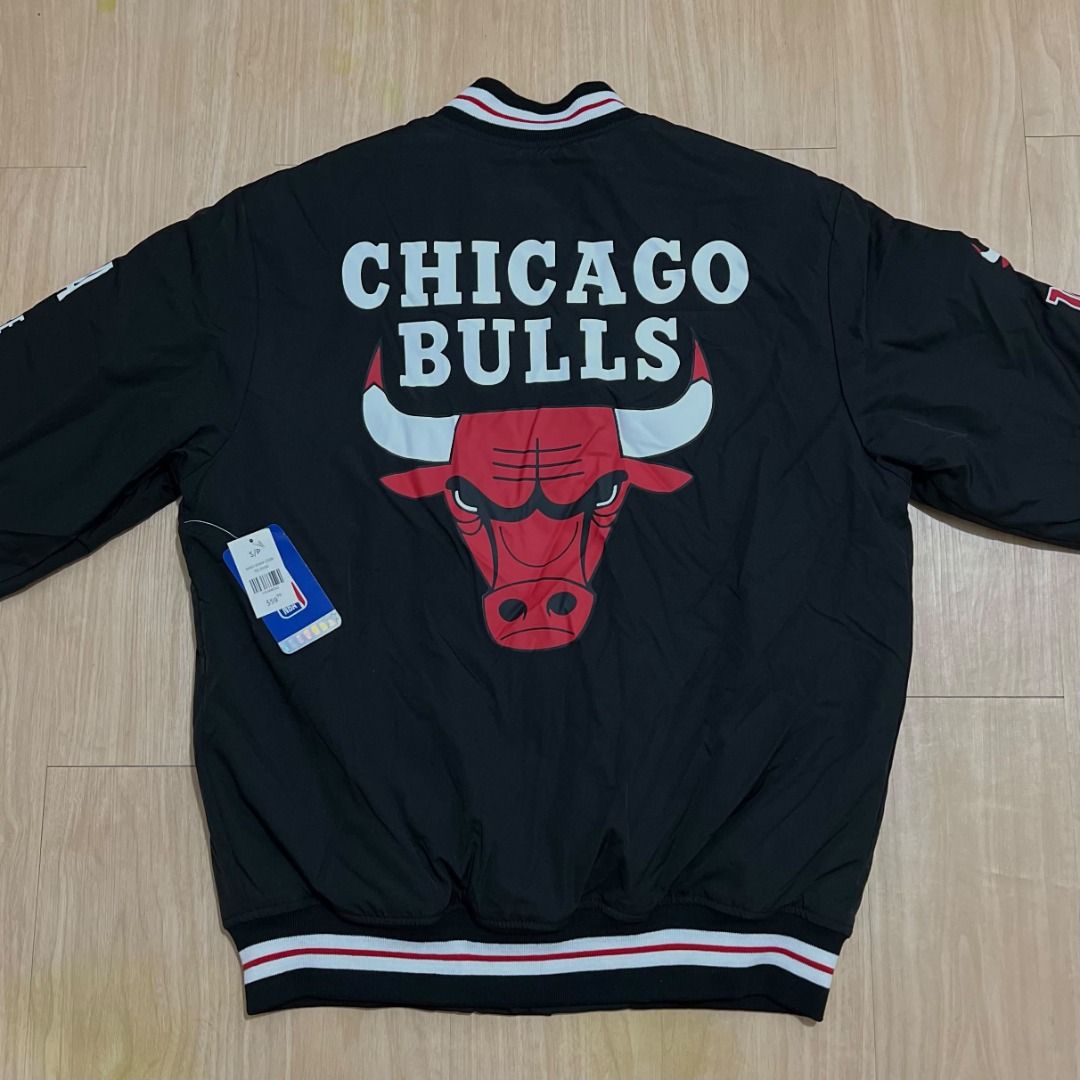 Chicago Bulls NBA Eastern Conference Varsity Bomber Jacket (Category: Coats, Jackets and Outerwear) located in Manila. Submitted by luxurybagsandshoes (Listing ID 1470232949, Image 2). Description: - Brand new with tags still attached - Color: Classic Black - Team: Chicago Bulls branding with large chest lettering and back bull logo - Accents: Unique patch details on both sleeves - Closure: Snap button front - Trim: Striped ribbed collar, cuffs, 