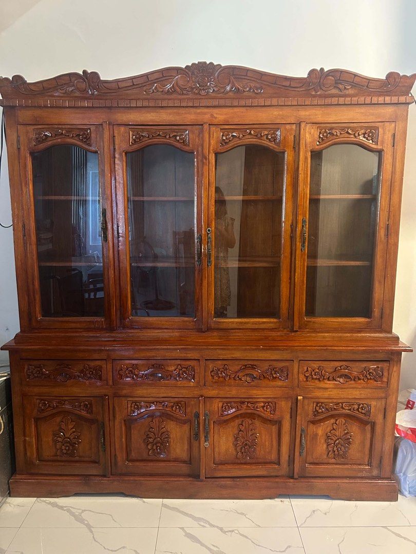 China Cabinet / Display Cabinet / Estante (Category: Shelves, Cabinets & Racks) located in Mandaluyong City. Submitted by l2ayne (Listing ID 1470210238, Image 1). Description: China Cabinet / Display Cabinet / Estante - Dimension: 6ft. Height 5ft. Width - Style: Classic traditional design with ornate floral carvings - Finish: Warm honey brown wood - Upper Section: 4 glass doors with internal wooden shelving - Lower Section: 4 spacious drawers and