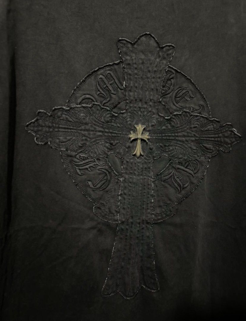 Chrome Hearts Black T-Shirt with Cross Patch Logo (Category: Tshirts & Polo Shirts ) located in Iba. Submitted by gotmethrift (Listing ID 1470295393, Image 3). Description: - Classic heavy cotton wash for a vintage feel - Front chest features the iconic round horseshoe logo patch - Statement large cross patch design on the back - Detailed with signature silver metal dagger hardware - Premium streetwear piece ideal for casual wear or layering - Co