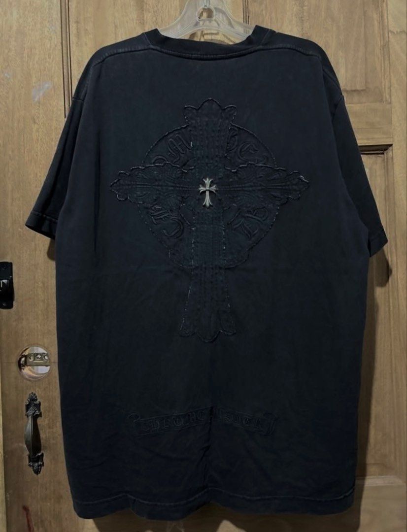 Chrome Hearts Black T-Shirt with Cross Patch Logo (Category: Tshirts & Polo Shirts ) located in Iba. Submitted by gotmethrift (Listing ID 1470295393, Image 2). Description: - Classic heavy cotton wash for a vintage feel - Front chest features the iconic round horseshoe logo patch - Statement large cross patch design on the back - Detailed with signature silver metal dagger hardware - Premium streetwear piece ideal for casual wear or layering - Co