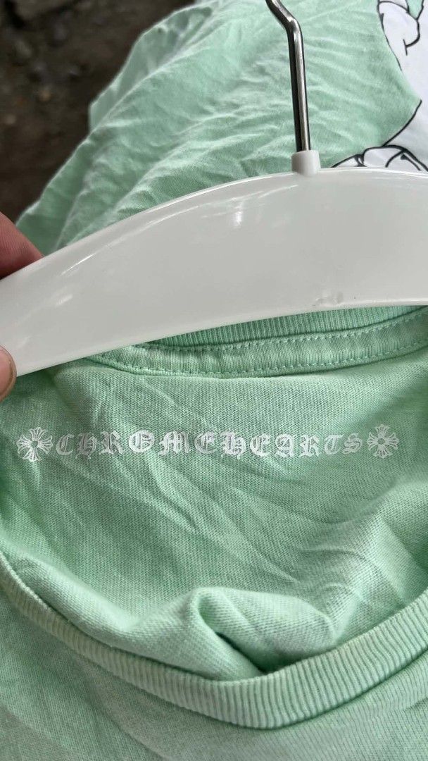 Chrome Hearts matty boy lust tee (Category: Tshirts & Polo Shirts ) located in San Jose. Submitted by garments17 (Listing ID 1470206070, Image 3). Description: hearing offers - Brand: Chrome Hearts - Color: Light green - Size: Medium (175/96B) - Design: Left chest pocket with red branding and 'LUST' graphic, striking large abstract print on the back - Fit: Short sleeves, crew neck style - Condition: Excellent, ready to wear.