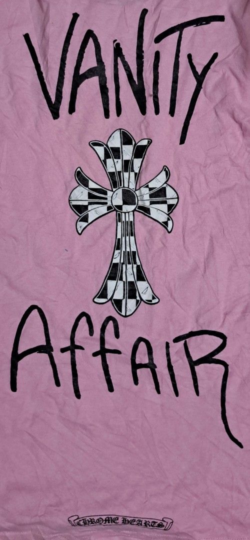 Chrome Hearts Pink Vanity Affair Pocket Tee (Category: Tshirts & Polo Shirts ) located in San Fernando, Camarines Sur. Submitted by ladderaya (Listing ID 1470242388, Image 2). Description: - Brand: Chrome Hearts - Color: Pink - Features: Chest pocket, 'Vanity Affair' graphic with checkered cross on the back, and checkerboard character near the bottom hem - Origin: Made in U.S.A. - Measurements: 26 inches (Length) x 18.5 inches (Width) - Condition