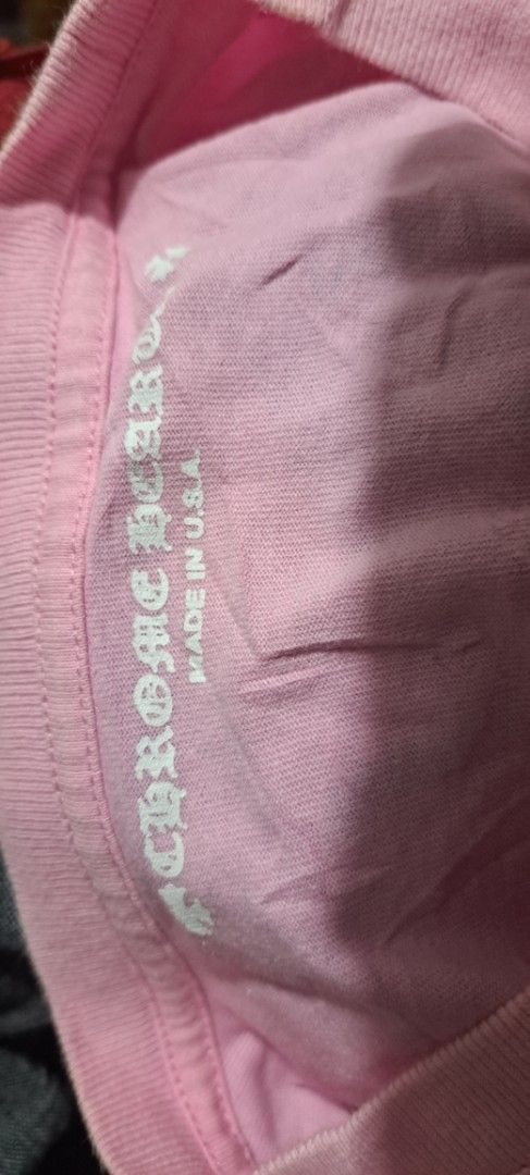 Chrome Hearts Pink Vanity Affair Pocket Tee (Category: Tshirts & Polo Shirts ) located in San Fernando, Camarines Sur. Submitted by ladderaya (Listing ID 1470242388, Image 3). Description: - Brand: Chrome Hearts - Color: Pink - Features: Chest pocket, 'Vanity Affair' graphic with checkered cross on the back, and checkerboard character near the bottom hem - Origin: Made in U.S.A. - Measurements: 26 inches (Length) x 18.5 inches (Width) - Condition