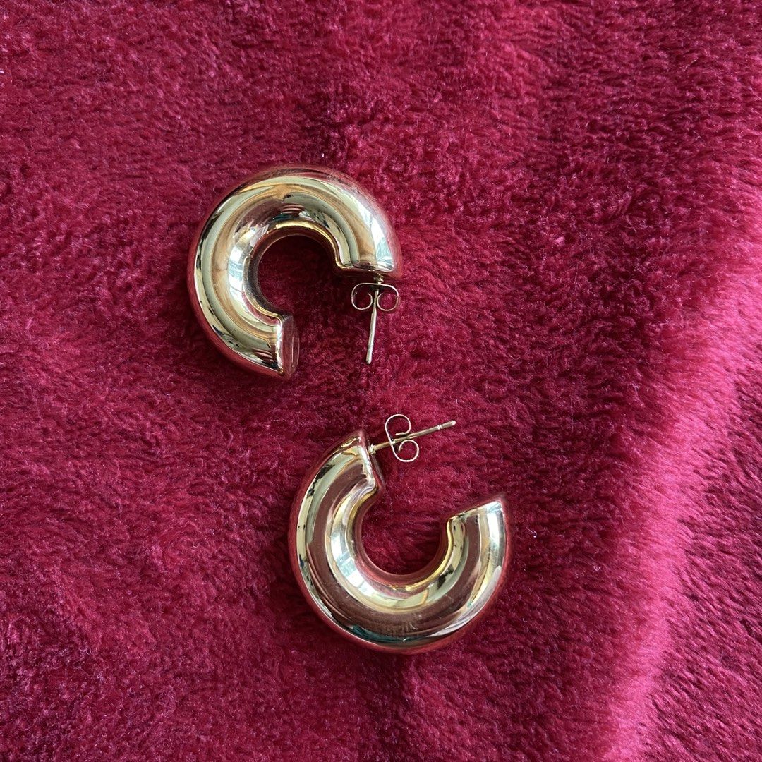 Chunky Gold Hoop Earrings (Category: Earrings) located in Baguio. Submitted by from.deana (Listing ID 1470166616, Image 3). Description: - Style: Thick gold plated hoops with a polished finish - Weight: Lightweight for all-day comfort - Closure: Standard post backings - Versatility: Bold statement piece for daily wear or going out - Condition: Clean and well-maintained.