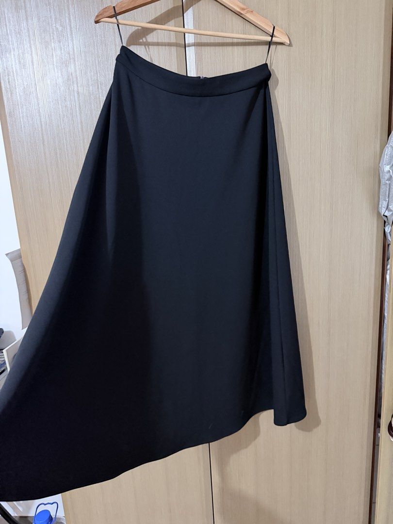 Classic black midi skirt with zip closure (Category: Skirts) located in Taguig. Submitted by mengxir20193848 (Listing ID 1470247881, Image 1). Description: - Color: Classic Black - Style: Flared A-line midi skirt with mid-rise waist - Closure: Hidden back zipper for a seamless look - Material: Smooth, nice-draping fabric - Versatility: Perfect for both office wear and casual outings - Easy to pair with basic tees or elegant blouses - Essential wa
