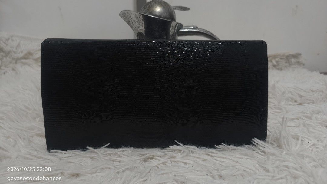 CLASSIC TEXTURED CLUTCH (Category: Clutches) located in Kalibo. Submitted by secondchances.thriftsh8p (Listing ID 1470312489, Image 2). Description: - Color: Classic black - Material: Textured faux lizard skin finish - Closure: Secure flap with snap button - Design: Sleek profile with clean edge stitching - Capacity: Compact size fits cards, cash, and phone easily - Versatility: Minimalist style, perfect for dinners and events.