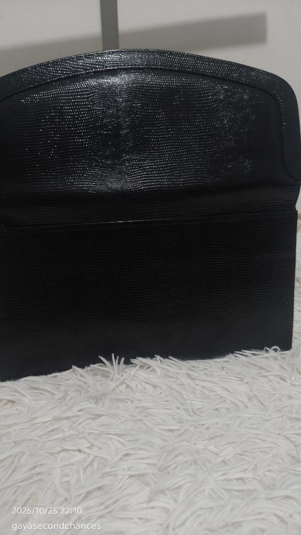 CLASSIC TEXTURED CLUTCH (Category: Clutches) located in Kalibo. Submitted by secondchances.thriftsh8p (Listing ID 1470312489, Image 3). Description: - Color: Classic black - Material: Textured faux lizard skin finish - Closure: Secure flap with snap button - Design: Sleek profile with clean edge stitching - Capacity: Compact size fits cards, cash, and phone easily - Versatility: Minimalist style, perfect for dinners and events.