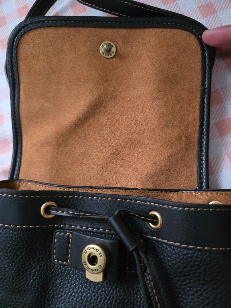 Coach Black Leather Backpack CH789 (Category: Backpacks) located in Antipolo. Submitted by pinkpandascloset (Listing ID 1470257131, Image 2). Description: - Brand: Coach - Material: Genuine black pebble leather with soft brown suede interior lining - Hardware: Elegant gold-tone accents throughout - Closure: Front flap with turnlock and secure drawstring main compartment - Pockets: Front flap pocket and ample space for daily essentials - Straps: A