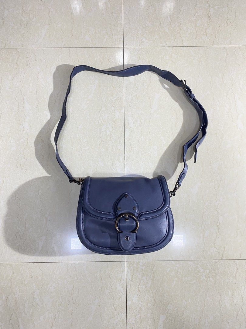 Coach Blue Leather Saddle Crossbody Bag (Category: Cross-body Bags) located in Dipolog. Submitted by jakelorenz41946 (Listing ID 1470293229, Image 1). Description: - Brand: Coach - Color: Classic Blue - Material: Premium Leather with dark hardware - Closure: Signature front flap turnlock - Strap: Long and fully adjustable - Design: Structured shape with elegant edge piping - Condition: Noticeable wear and scuffs on the metal buckle closure - Inte