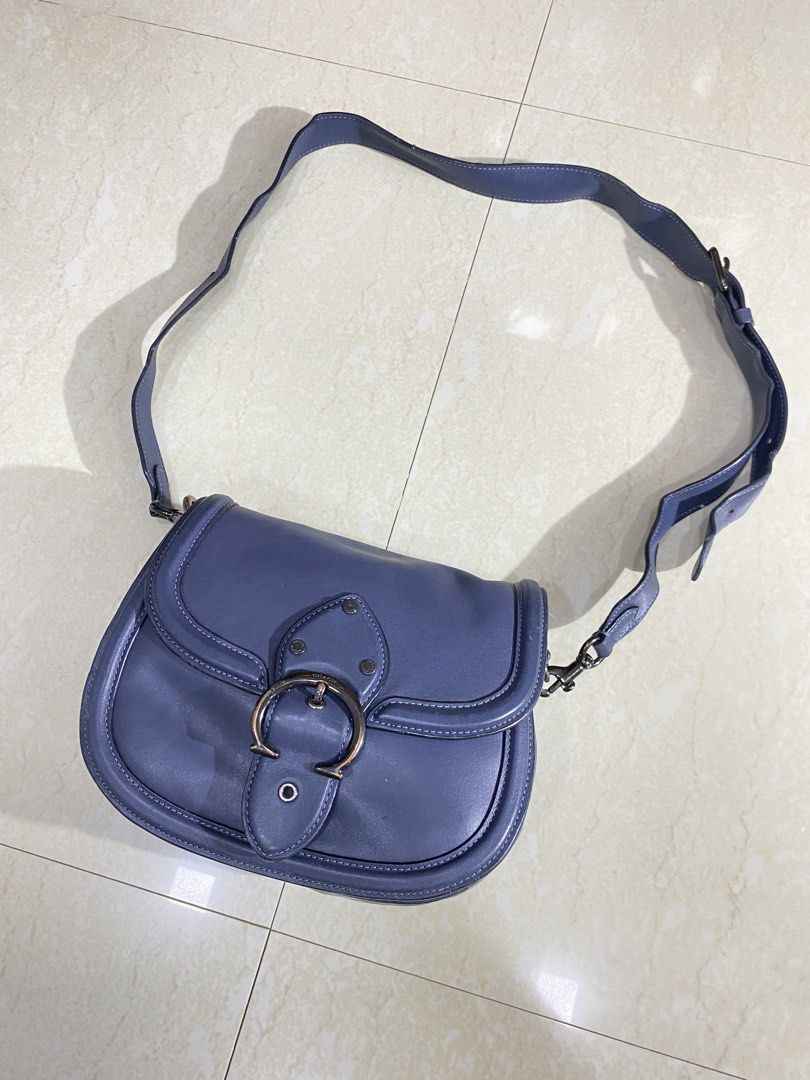 Coach Blue Leather Saddle Crossbody Bag (Category: Cross-body Bags) located in Dipolog. Submitted by jakelorenz41946 (Listing ID 1470293229, Image 2). Description: - Brand: Coach - Color: Classic Blue - Material: Premium Leather with dark hardware - Closure: Signature front flap turnlock - Strap: Long and fully adjustable - Design: Structured shape with elegant edge piping - Condition: Noticeable wear and scuffs on the metal buckle closure - Inte