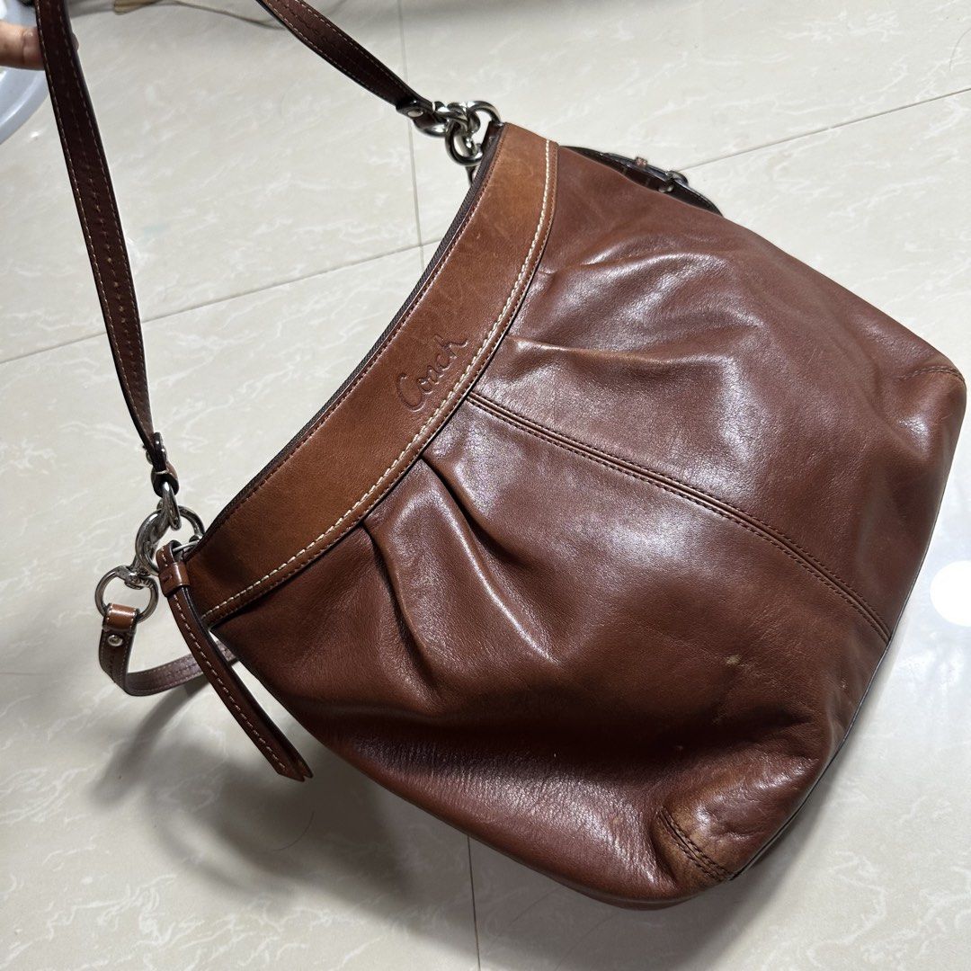 Coach Brown Leather Shoulder Bag with Adjustable Strap (Category: Luxury Bags & Wallets) located in Manila. Submitted by direcmampu37948 (Listing ID 1470245051, Image 2). Description: - Brand: Coach - Color: Classic Brown - Material: Premium Leather - Closure: Secure zip-top - Hardware: Silver-tone throughout - Design Features: Soft pleated front, structured base, and embossed logo near the top rim - Straps Included: Comes with both a short shoul