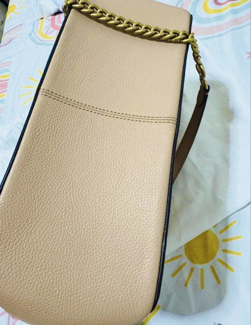 Coach Bryant Convertible Bag (Category: Luxury Bags & Wallets) located in Manila. Submitted by 95ybbrf8bx80014 (Listing ID 1470316895, Image 2). Description: - Brand: Coach - Color: Beige - Material: Textured leather - Hardware: Antique brass chain strap with leather shoulder guard & gold-tone logo lettering - Design: Structured rectangular shape with side gussets - Condition: Clean stitching details along edges and sides.