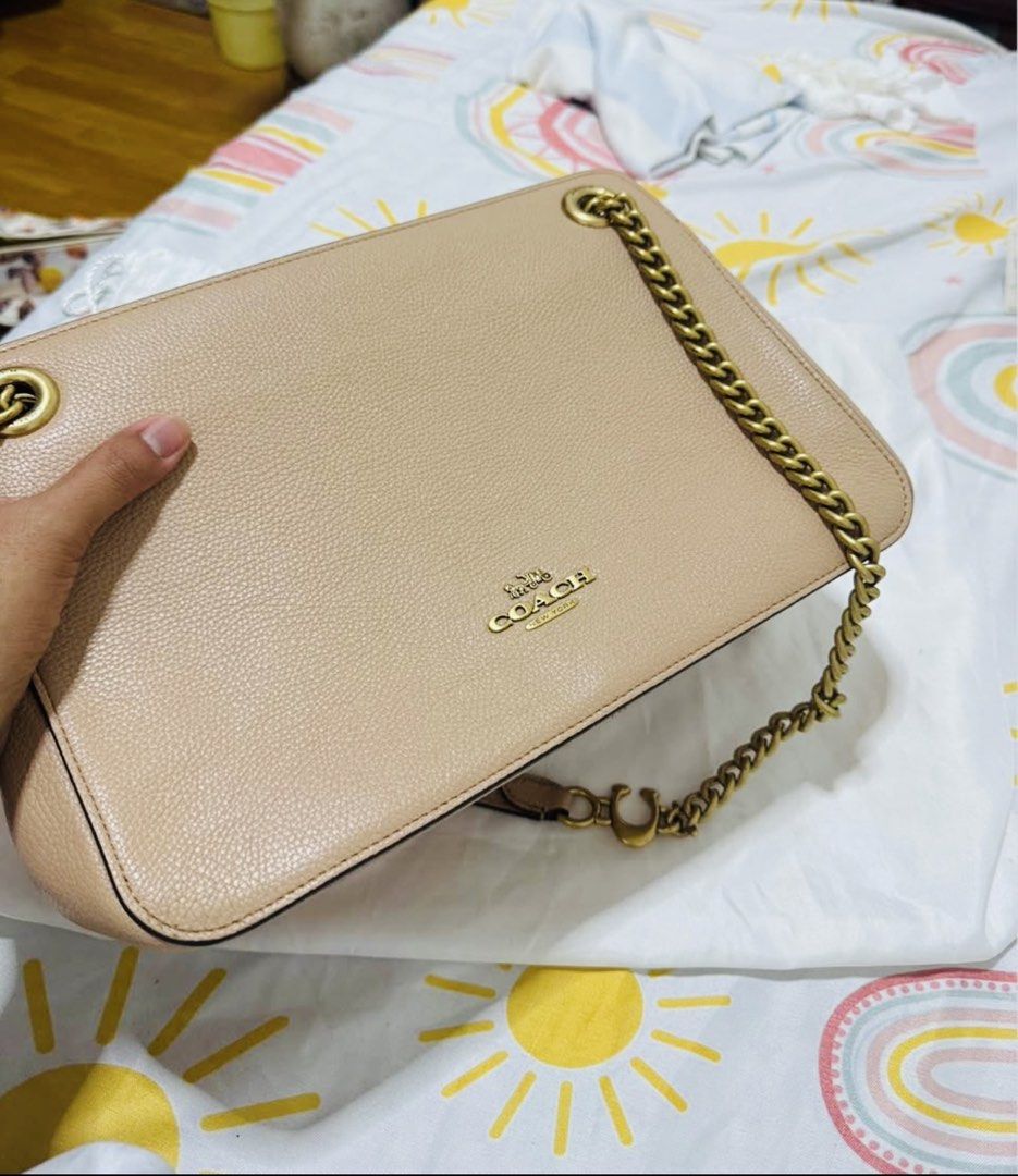 Coach Bryant Convertible Bag (Category: Luxury Bags & Wallets) located in Manila. Submitted by 95ybbrf8bx80014 (Listing ID 1470316895, Image 1). Description: - Brand: Coach - Color: Beige - Material: Textured leather - Hardware: Antique brass chain strap with leather shoulder guard & gold-tone logo lettering - Design: Structured rectangular shape with side gussets - Condition: Clean stitching details along edges and sides.