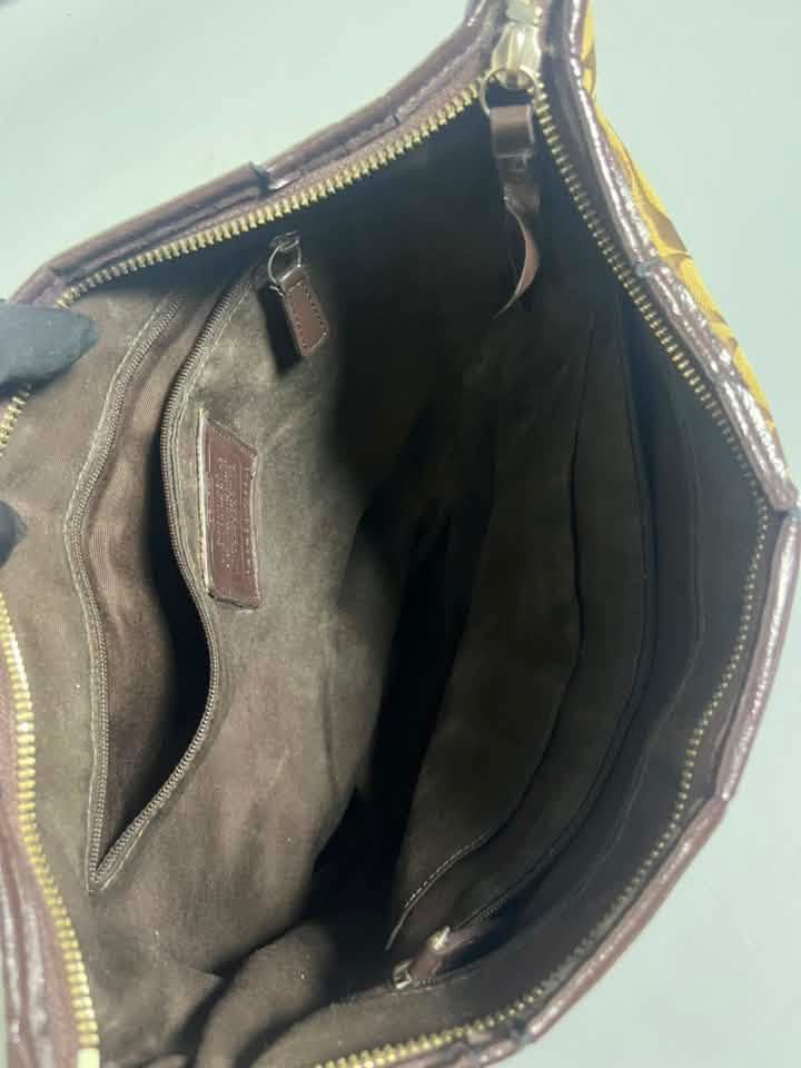 Coach Campbell Signature Medium Hobo (Category: Luxury Bags & Wallets) located in Manila. Submitted by royalpengwen (Listing ID 1470308866, Image 3). Description: - Authentic Coach shoulder bag in brown signature C canvas - Features a chic vertical brown stripe detail on the back - Single dark brown shoulder strap for comfortable wear - Secure zip-top closure to keep your essentials safe - Dark brown fabric interior with slip and zippered pockets