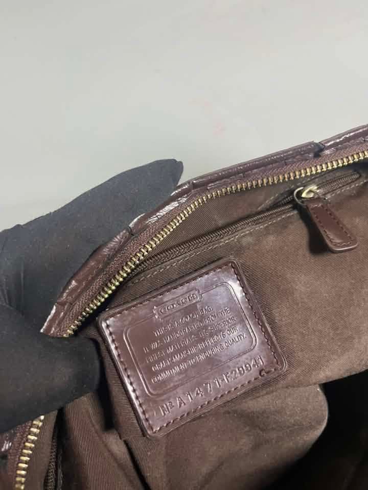 Coach Campbell Signature Medium Hobo (Category: Luxury Bags & Wallets) located in Manila. Submitted by royalpengwen (Listing ID 1470308866, Image 2). Description: - Authentic Coach shoulder bag in brown signature C canvas - Features a chic vertical brown stripe detail on the back - Single dark brown shoulder strap for comfortable wear - Secure zip-top closure to keep your essentials safe - Dark brown fabric interior with slip and zippered pockets