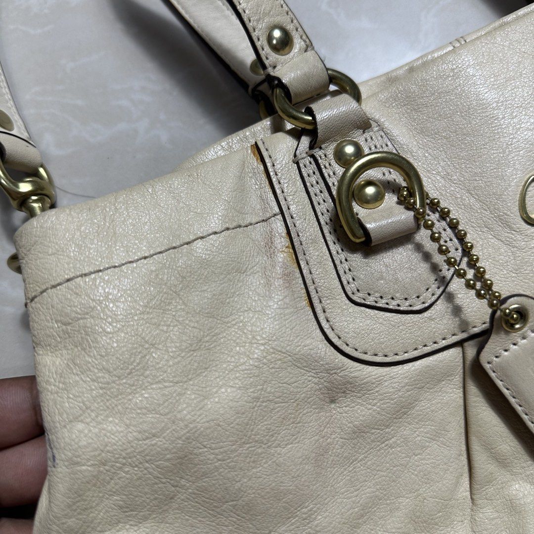 Coach Cream Leather Shoulder Bag (Category: Luxury Bags & Wallets) located in Manila. Submitted by direcmampu37948 (Listing ID 1470245001, Image 2). Description: - Brand: Coach - Material: Genuine leather in a versatile cream shade - Hardware: Gold-tone with metallic Coach logo lettering - Features: Double top handles, detachable shoulder strap, pleated front detail, and signature Coach hangtag - Condition: Pre-owned with minor discoloration and 