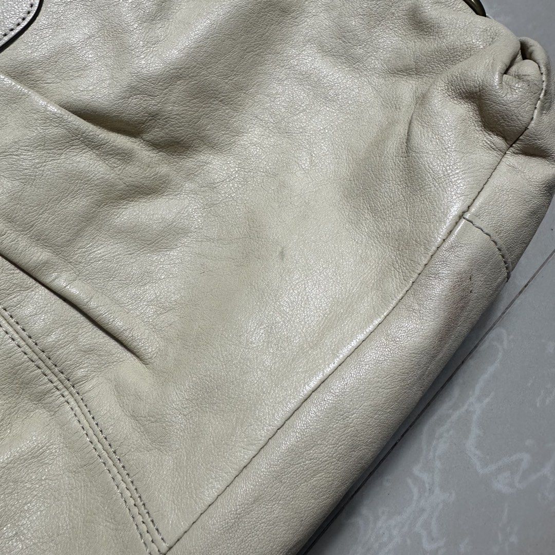 Coach Cream Leather Shoulder Bag (Category: Luxury Bags & Wallets) located in Manila. Submitted by direcmampu37948 (Listing ID 1470245001, Image 3). Description: - Brand: Coach - Material: Genuine leather in a versatile cream shade - Hardware: Gold-tone with metallic Coach logo lettering - Features: Double top handles, detachable shoulder strap, pleated front detail, and signature Coach hangtag - Condition: Pre-owned with minor discoloration and 