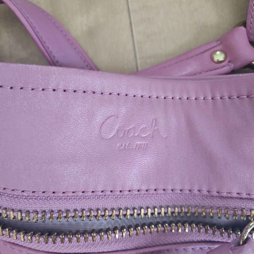 Coach Full-Grain Cowhide Leather Shoulder Bag Pink (Category: Luxury Bags & Wallets) located in Malabon City. Submitted by si.narcisa (Listing ID 1470235721, Image 3). Description: - Brand: Coach - Material: Full-grain cowhide leather in soft pink - Hardware: Brass-tone - Features: Front zip pocket, gathered pleat details, detachable shoulder strap, and matching hangtag - Interior: Light-colored fabric lining with creed patch (E1093-F13411) - Con