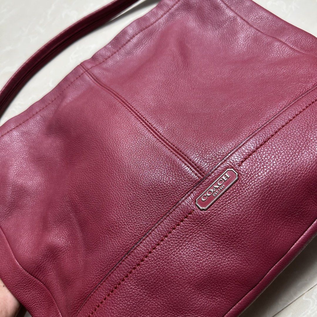 Coach Leather Shoulder Bag Burgundy (Category: Luxury Bags & Wallets) located in Manila. Submitted by direcmampu37948 (Listing ID 1470244880, Image 2). Description: - Brand: Coach - Material: Premium deep burgundy pebbled leather - Hardware: Silver-tone metal with front logo plaque - Closure: Top zipper closure - Strap: Single shoulder strap with metallic rings - Condition: Clean interior and exterior, minimal wear - Design: Structured base with 