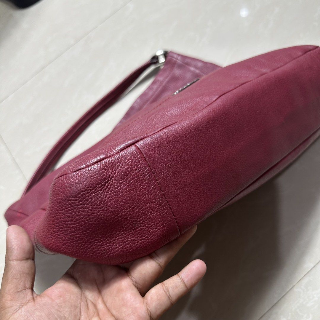 Coach Leather Shoulder Bag Burgundy (Category: Luxury Bags & Wallets) located in Manila. Submitted by direcmampu37948 (Listing ID 1470244880, Image 3). Description: - Brand: Coach - Material: Premium deep burgundy pebbled leather - Hardware: Silver-tone metal with front logo plaque - Closure: Top zipper closure - Strap: Single shoulder strap with metallic rings - Condition: Clean interior and exterior, minimal wear - Design: Structured base with 