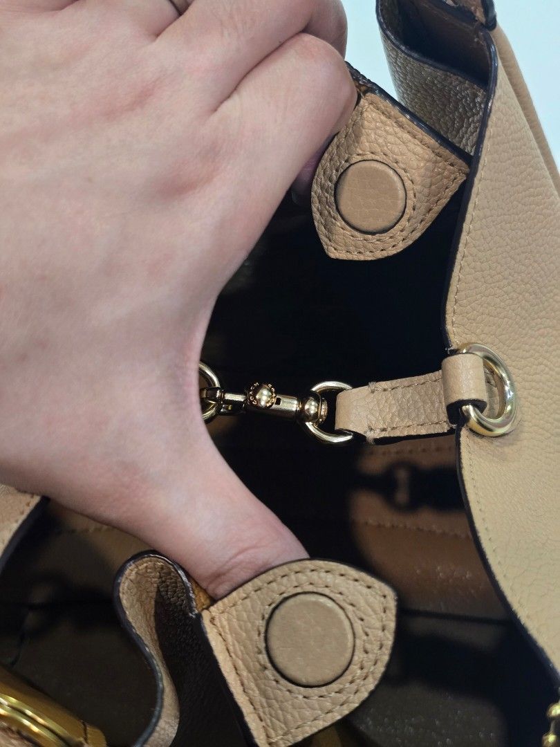Coach Leather Shoulder Bag with Cherry Charm (Category: Luxury Bags & Wallets) located in Imus. Submitted by chie0308 (Listing ID 1470286296, Image 2). Description: - Authentic Coach pebbled leather bag in beige - Includes a detachable strap for versatile styling - Comes with a cute glittery red cherry bag charm - Features inside Coach story patch (N8 H1980-78800) and Made in Vietnam tag Like new, no issues. with FREE Coach cherry charm bag ‼️ Im